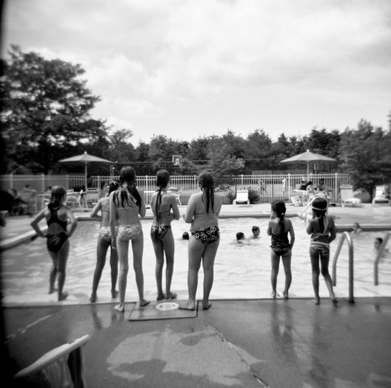 photo of girls standing poolside