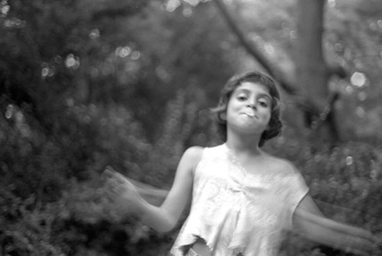 A girl skipping rope while blowing bubbles