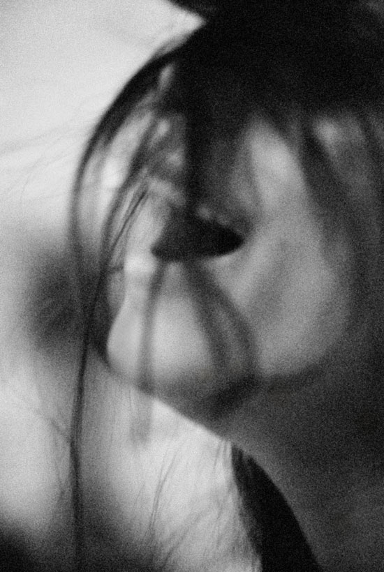 black & white photo of a girl flipping her hair.