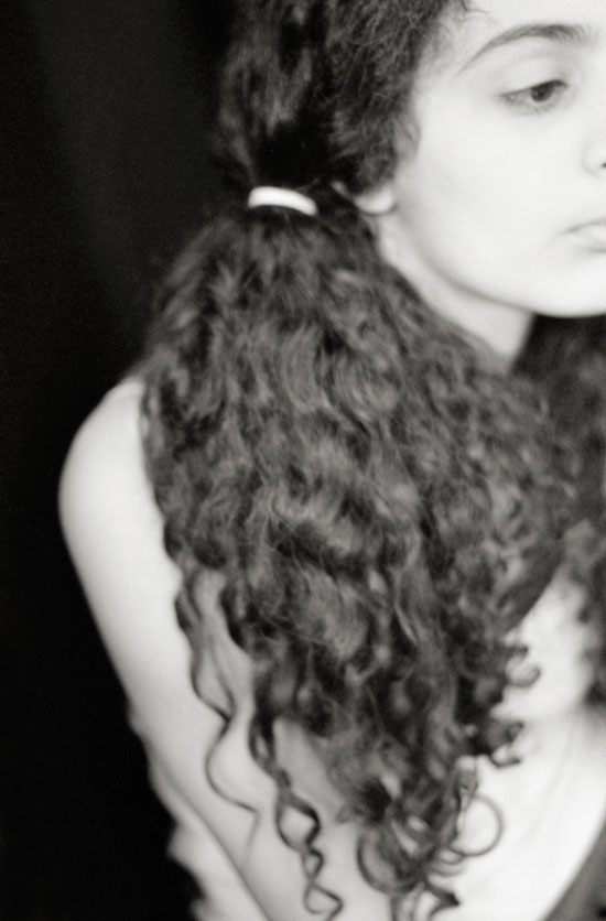 black & white portrait of a young girl with curly pig tails